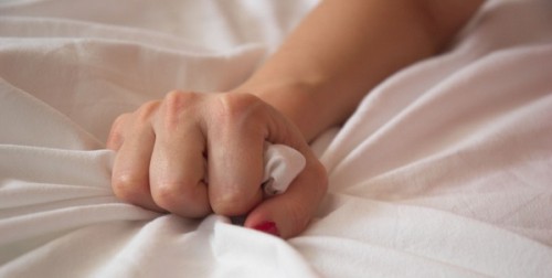 Woman s Hand Squeezing Bed Sheet